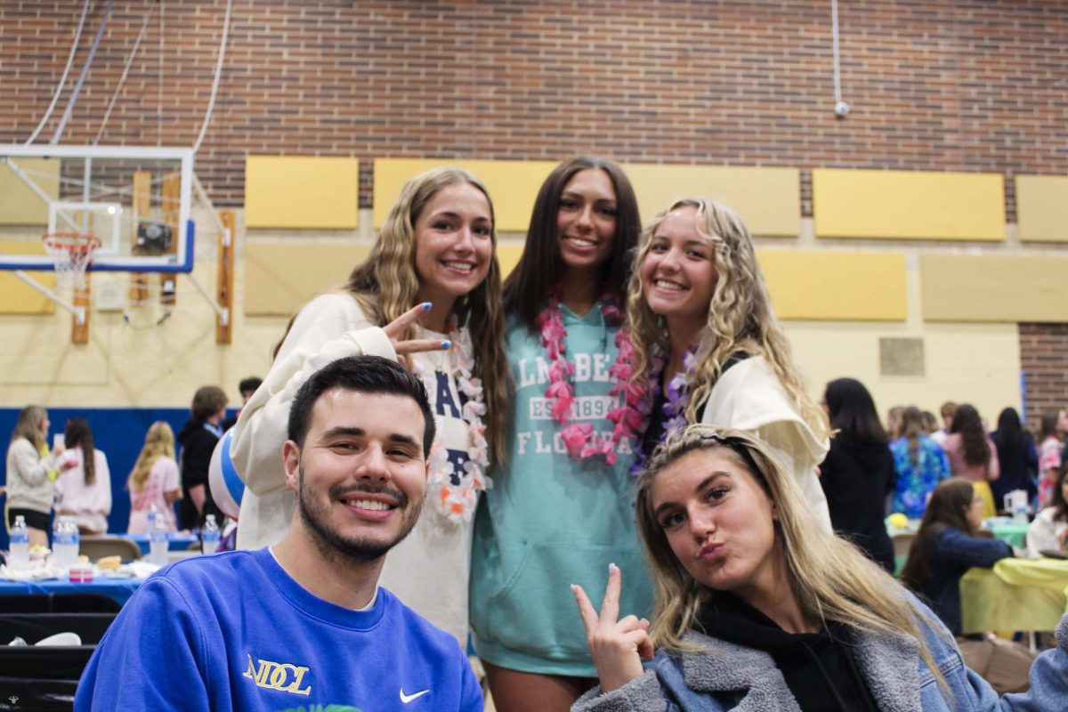 Seniors posing with Year book member, Hope Lassnick and Campus Minister, Mr. Carillion